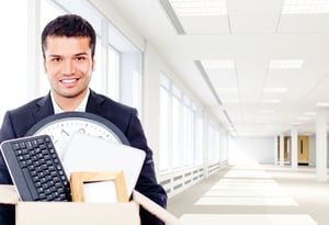Businessman moving into a new office holding a box