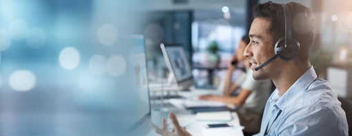 Man in a telemarketing call center talking online via microphone